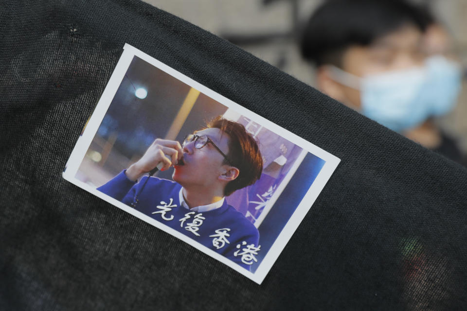 A sticker featuring a picture of Hong Kong activist Edward Leung with Chinese words which read "Liberate Hong Kong," is displayed outside the High Court in Hong Kong, Wednesday, Oct. 9, 2019. Last year, Leung was sentenced to six years in prison for his part in a violent nightlong clash with police over illegal street food hawkers two years ago. (AP Photo/Kin Cheung)