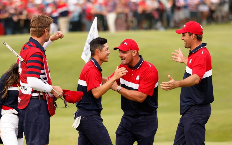  Team USA's Collin Morikawa celebrates with Team USA's Bryson DeChambeau and Team USA's Scottie Scheffler - Reuters