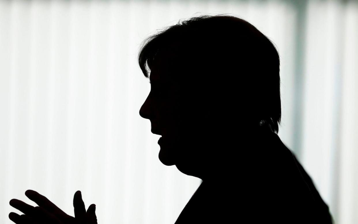 German Chancellor Angela Merkel silhouettes in front of a window as she briefs the media after a meeting with governors of eastern German states at the Chancellery in Berlin, Germany, Wednesday, May 27, 2020. (Photo by Markus Schreiber / POOL / AFP) (Photo by MARKUS SCHREIBER/POOL/AFP via Getty Images) - MARKUS SCHREIBER/AFP