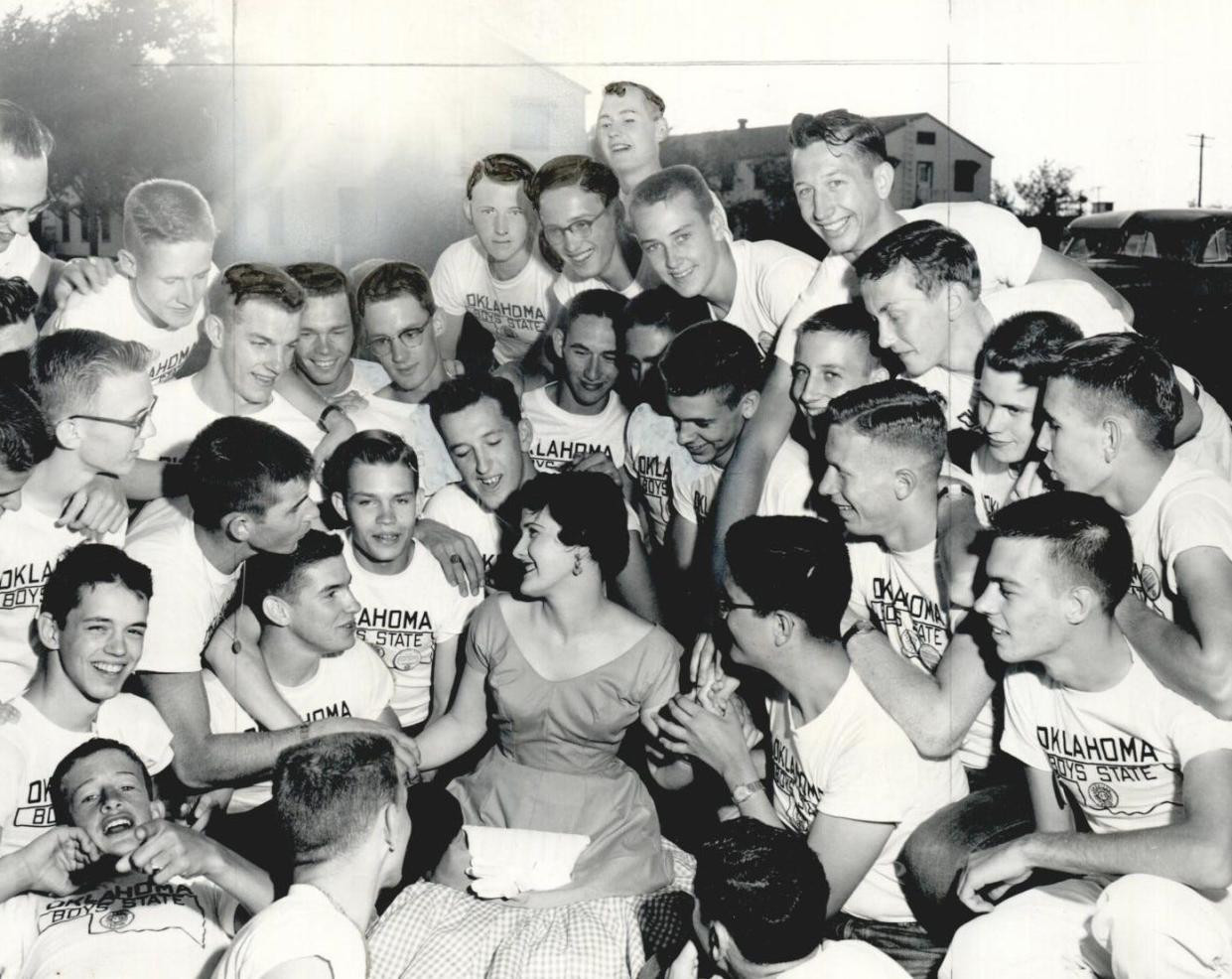 On June 8, 1955, Pat Phillips, the previous year's governor of Girls' State, poses for a photo with participants of Boys' State.