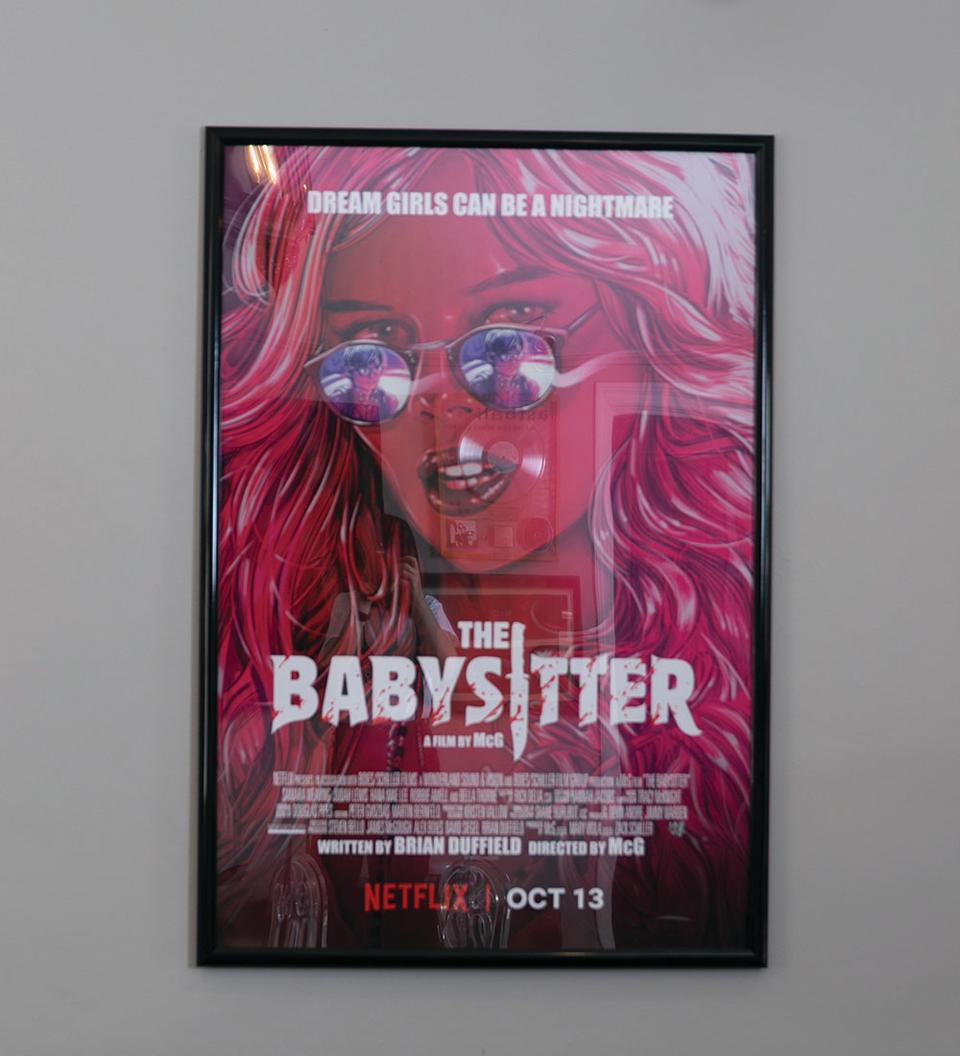 A poster for one of his bigger Netflix successes (The Babysitter) - Credit: Photographed by Emily Malan