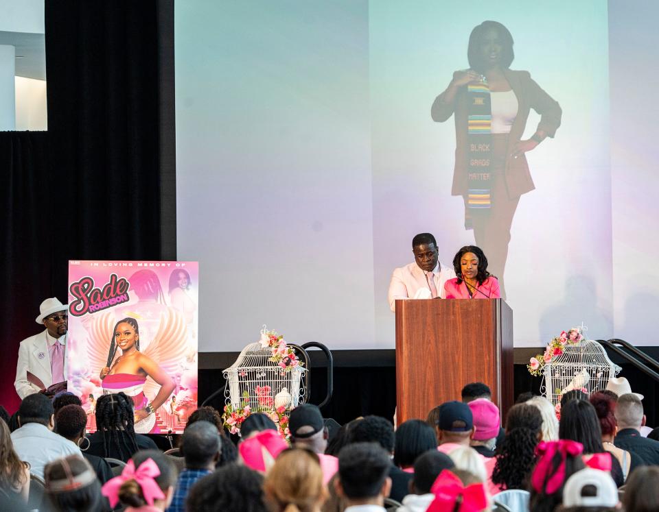 Carlos Robinson, left, father of Sade Robinson, and Sheena Scarbrough, right, her mother, speak about their memories of their daughter at the public memorial service May 10 at the Baird Center.