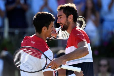 Tennis - ATP 500 - Fever-Tree Championships - The Queen's Club, London, Britain - June 24, 2018 Croatia's Marin Cilic hugs Serbia's Novak Djokovic after their final Action Images via Reuters/Tony O'Brien