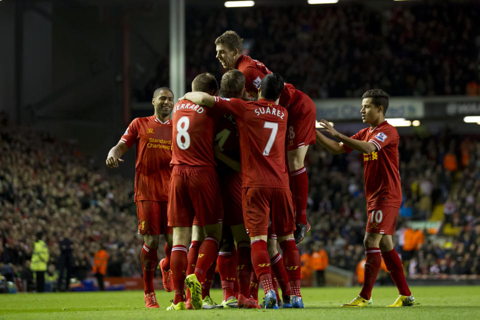 Liverpool's Daniel Sturridge is swamped by jubilant teammates including Jon Flanagan, top, after scoring against Sunderland during their English Premier League soccer match at Anfield Stadium, Liverpool, England, Wednesday March 26, 2014. (AP Photo/Jon Super)