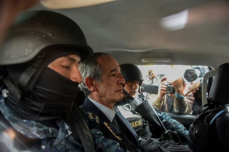 Former Guatemalan president Alvaro Colom (center) is arrested on corruption charges in Guatemala City on February 13, 2018