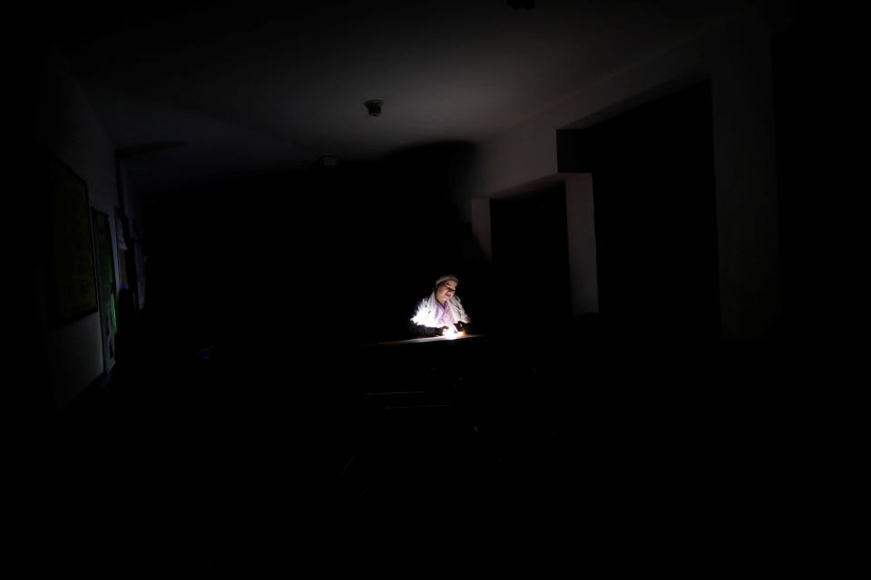 A nurse waits for the electricity to return at a dialysis center during a blackout in Maracaibo, Venezuela. (Photo: Ueslei Marcelino/Reuters)