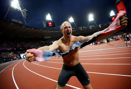 Germany's Robert Harting celebrates after winning the men's discus throw final during the London 2012 Olympic Games at the Olympic Stadium in Britain August 7, 2012. REUTERS/Kai Pfaffenbach