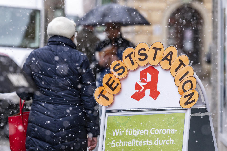 A sign reads "Test station"" in front of a pharmacy in Vilshofen, Germany, Tuesday, Nov. 30, 2021. The number of new corona infections per 100,000 inhabitants in the district of Passau is currently over 1000. (Armin Weigel/dpa via AP)