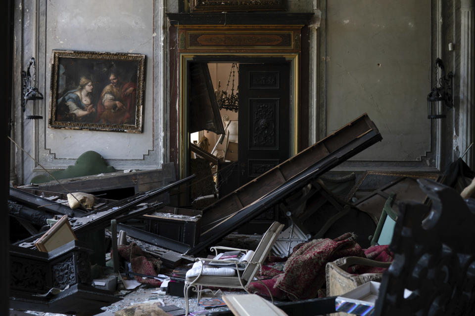 A painting hangs on the wall of a heavily damaged room in the Sursock Palace after the explosion in the seaport of Beirut, Lebanon, Saturday, Aug. 8, 2020. The level of destruction from the massive explosion at Beirut's port last week is ten times worse than what 15 years of civil war did. (AP Photo/Felipe Dana)