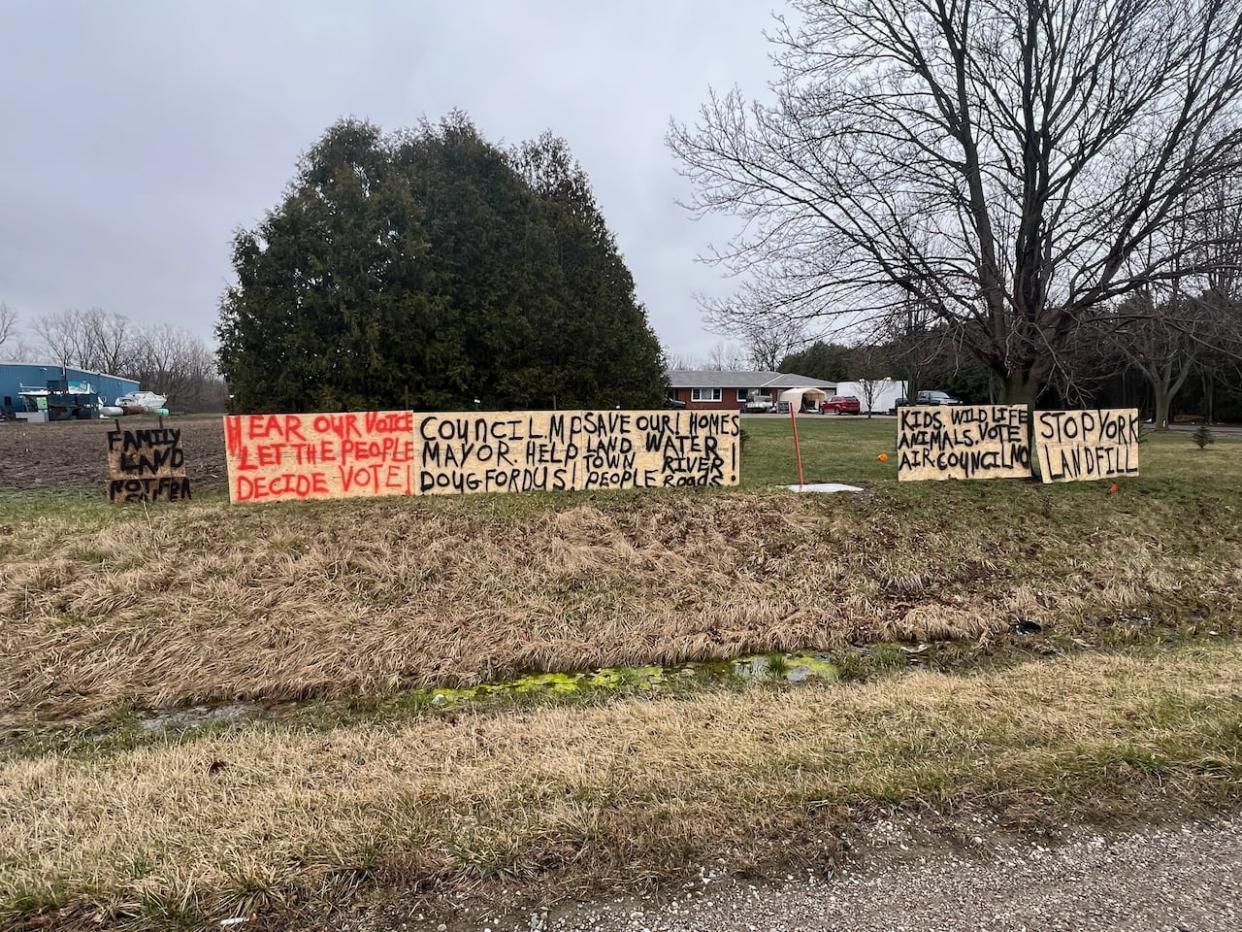 Signs against a proposed landfill in Dresden, Ont., are shown on the property of John Lamers. (Submitted by Tim Lamers - image credit)