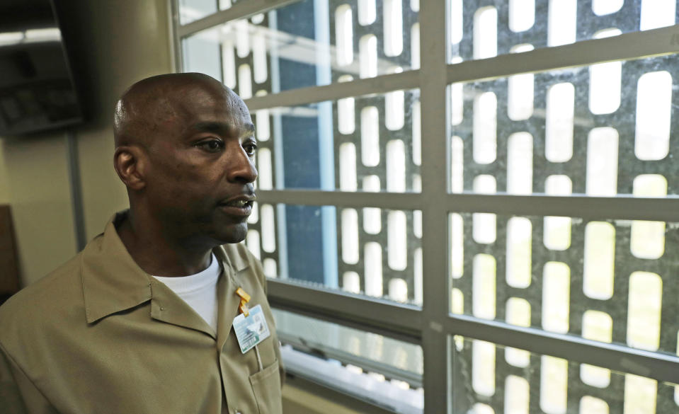 In this May 9, 2019 photo, Devon Laird poses for a photo in the Washington Correctional Center in Shelton, Wash. Laird is among a small group of inmates who are set to stay in Washington state prisons for life who were left out of the latest in a multi-year wave of reforms easing tough-on-crime "three strikes" laws around the U.S. (AP Photo/Ted S. Warren)