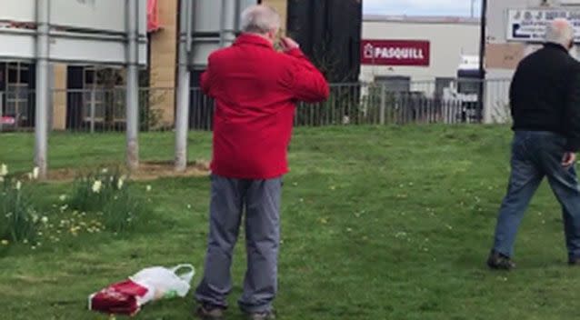 The man in the red jacket puts on his glasses while the other man calmly walks off. Source: Facebook