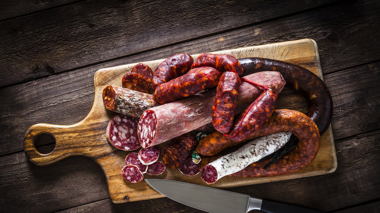 assortment of sausages on cutting board 