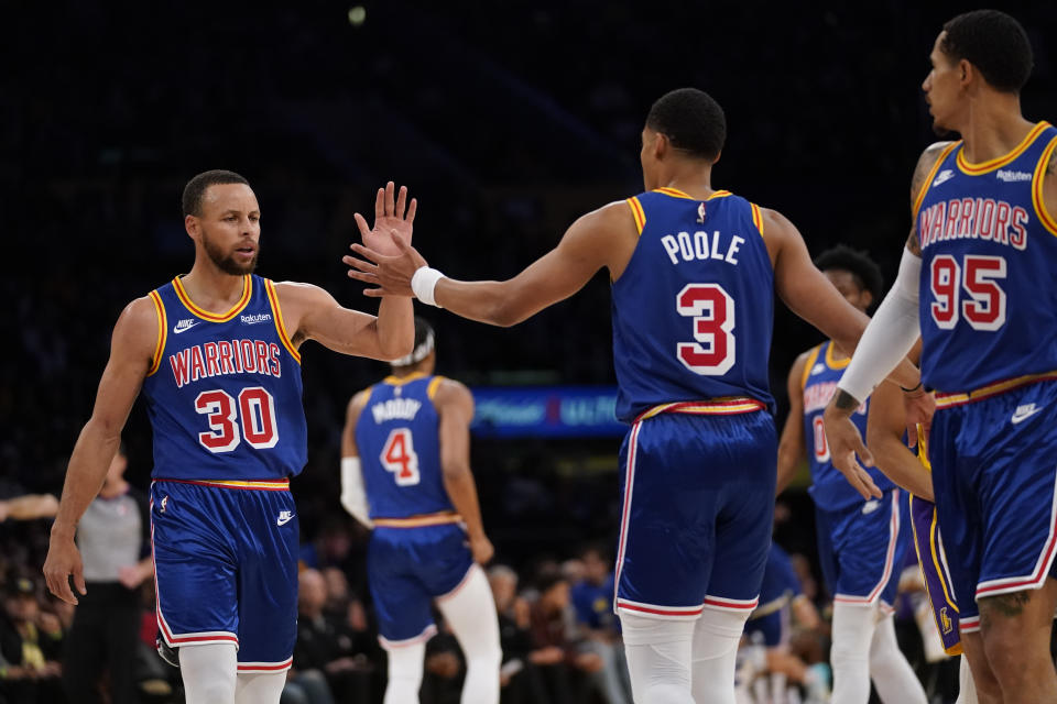 Golden State Warriors guard Stephen Curry (30) high-fives guard Jordan Poole (3) after a 3-pointer during the first half of an NBA basketball game against the Los Angeles Lakers in Los Angeles, Saturday, March 5, 2022. (AP Photo/Ashley Landis)