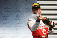 SPA, BELGIUM - SEPTEMBER 02: Jenson Button of Great Britain and McLaren celebrates on the podium after winning the Belgian Grand Prix at the Circuit of Spa Francorchamps on September 2, 2012 in Spa Francorchamps, Belgium. (Photo by Mark Thompson/Getty Images)