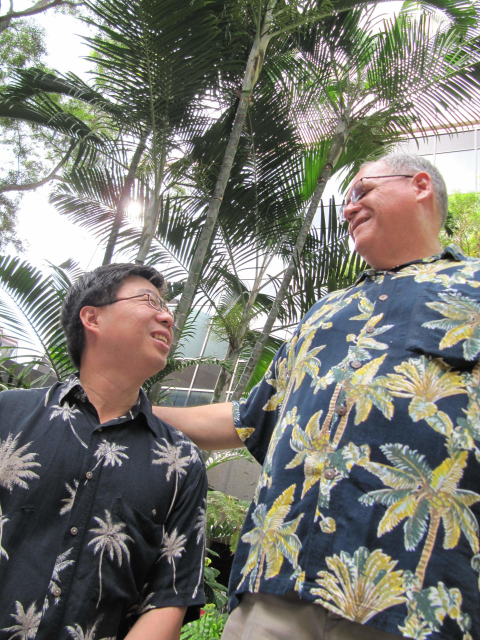 Ethan Wung, left, and Keola Akana pose for photos in Honolulu on Friday, Nov. 29, 2013. They will be among the first same-sex couples to be legally married in Hawaii on Dec. 2, when a new law allowing gay couples to marry takes effect. (AP Photo/Jennifer Sinco Kelleher).