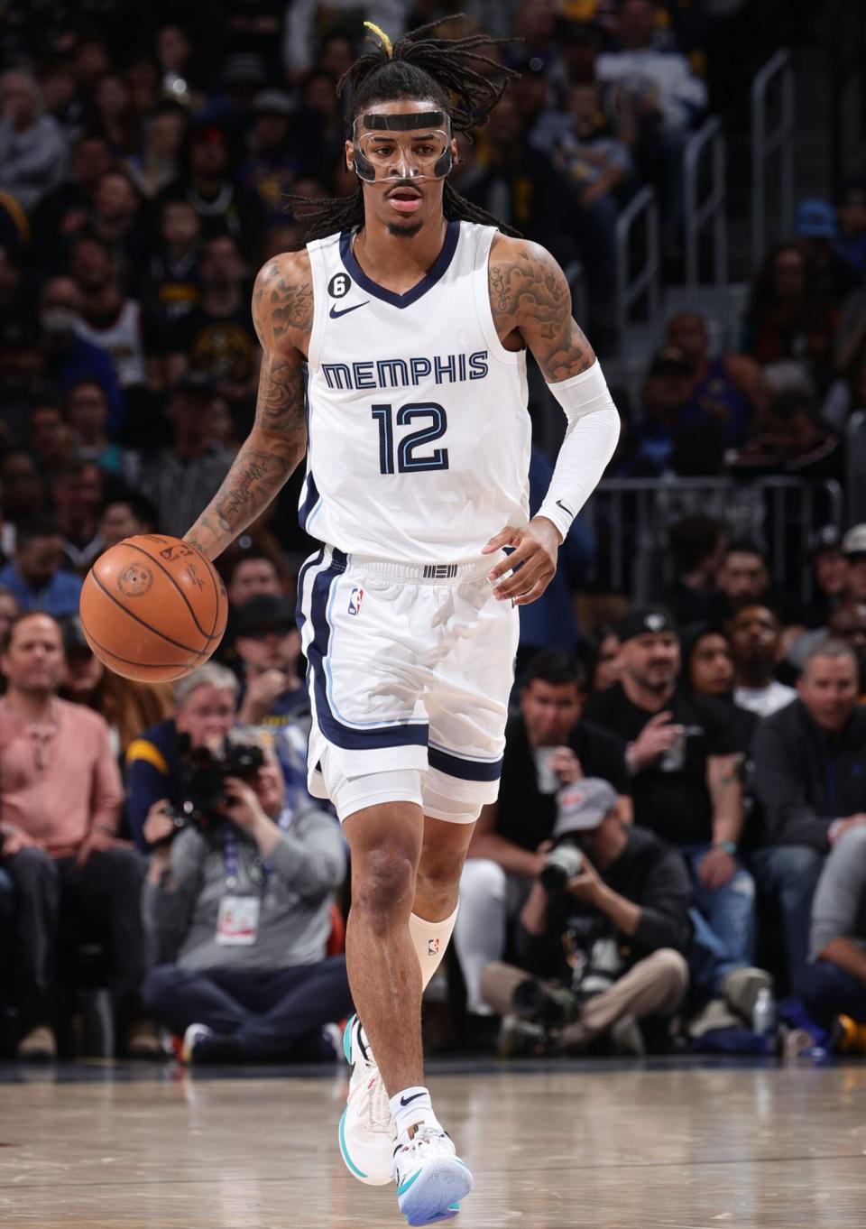 Ja Morant #12 of the Memphis Grizzlies dribbles the ball during the game against the Denver Nuggets on March 3, 2023