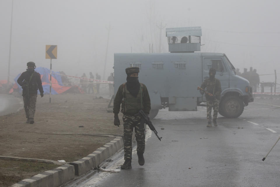 Indian paramilitary soldiers patrol near the site of Thursday's explosion in Pampore, Indian-controlled Kashmir, Friday, Feb. 15, 2019. Security officials say the death toll from a car bombing in Indian-controlled Kashmir has climbed to at least 40 after rebels fighting against Indian rule struck a paramilitary convoy in the single deadliest attack in the divided region's volatile history. (AP Photo/Dar Yasin)