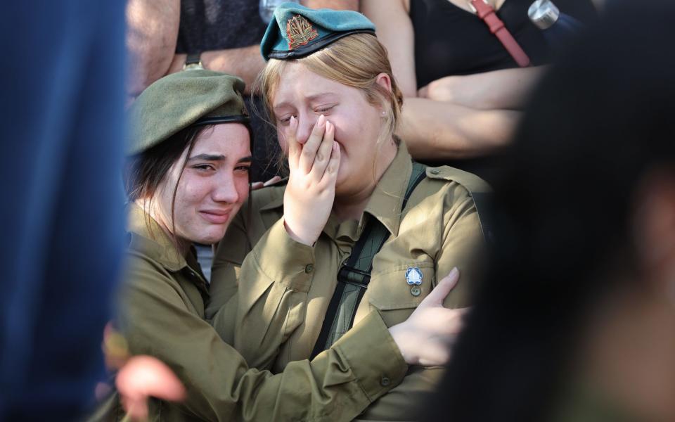 Israeli soldiers mourn during the funeral of  Noa Marciano