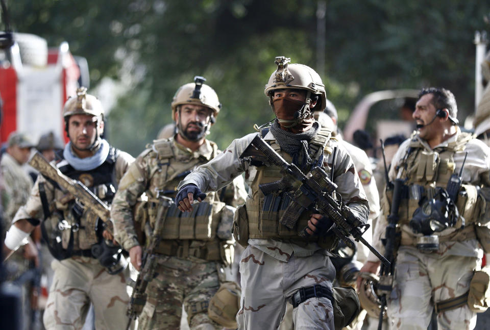 <p>Afghan security officials secure the roads leading to the Iraqi embassy after an attack allegedly carried out by the Islamic State, in Kabul, Afghanistan, July 31, 2017. (Jawad Jalali/EPA/REX/Shutterstock) </p>