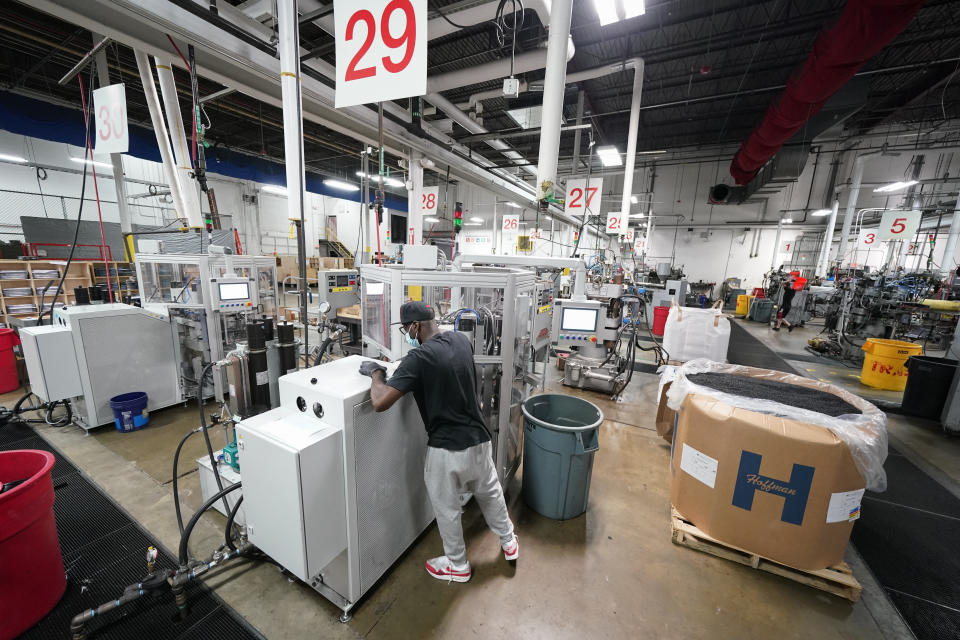 Workers operate record-pressing machinery at the United Record Pressing facility Thursday, June 23, 2022, in Nashville, Tenn. (AP Photo/Mark Humphrey)