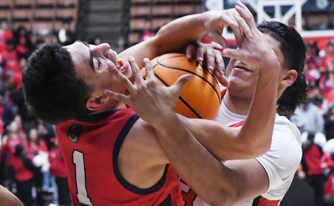 Tulare Western’s Carmine Ficher, left, struggles for control against Kerman’s Maximus Minnite, right, at the CIF Central Section Division IV basketball championship Friday, Feb. 24, 2023 in Fresno. Tulare Western won 60-40.