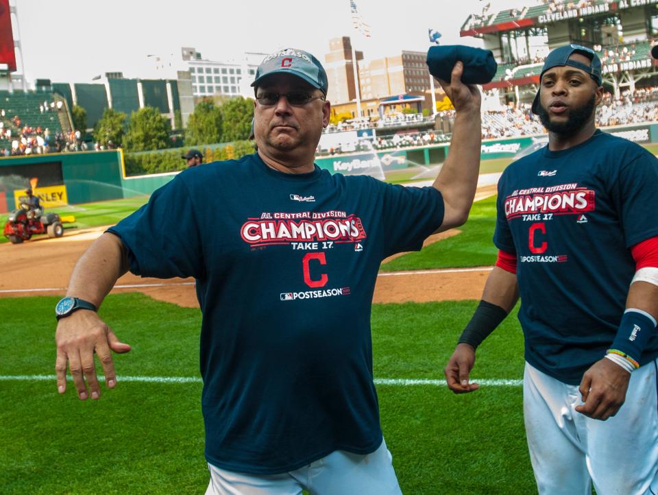 Cleveland manager Terry Francona throws a shirt to the crowd as Carlos Santana watches as the team celebrates winning the American League Central Division after beating Kansas City, Sunday, Sept. 17, 2017, in Cleveland.