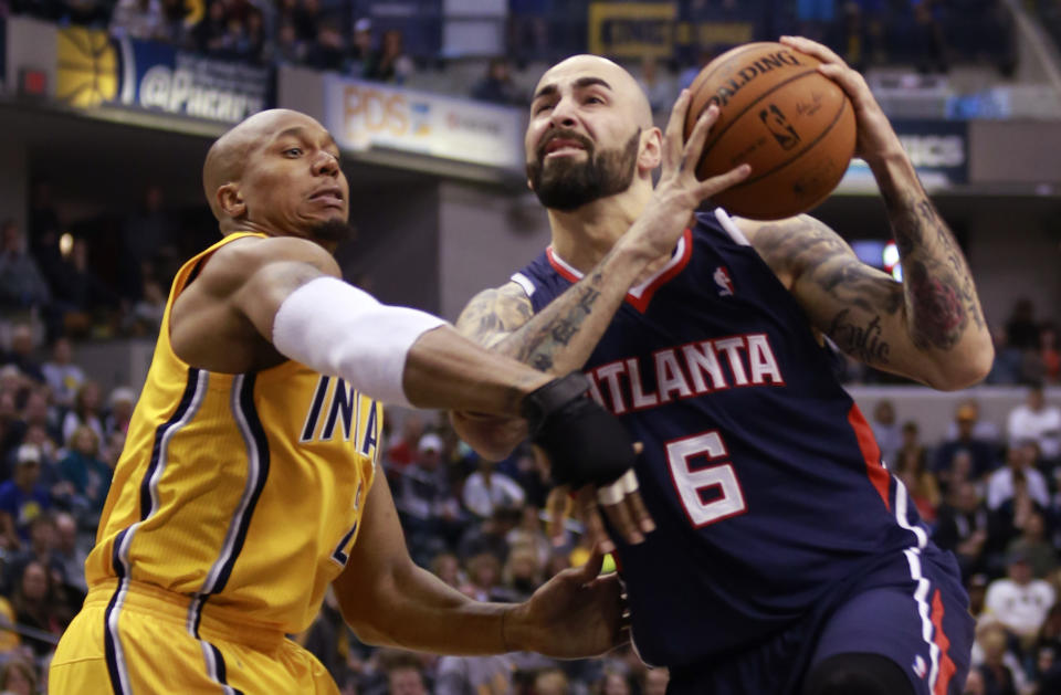 Indiana Pacers forward David West, left, fouls Atlanta Hawks center Pero Antic in the first half of an NBA basketball game in Indianapolis, Sunday, April 6, 2014. Atlanta won 107-88. (AP Photo/R Brent Smith)