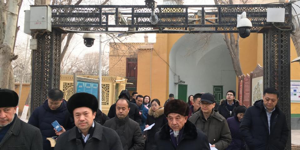 FILE PHOTO: Imams and government officials pass under security cameras as they leave the Id Kah Mosque during a government organised trip in Kashgar, Xinjiang Uighur Autonomous Region, China, January 4, 2019. REUTERS/Ben Blanchard