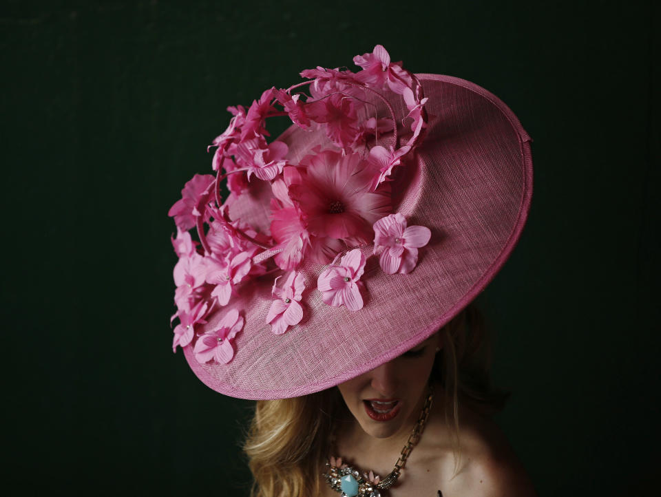 A woman makes her way to the track before the 140th running of the Kentucky Derby horse race at Churchill Downs Saturday, May 3, 2014, in Louisville, Ky. (AP Photo/Matt Slocum)