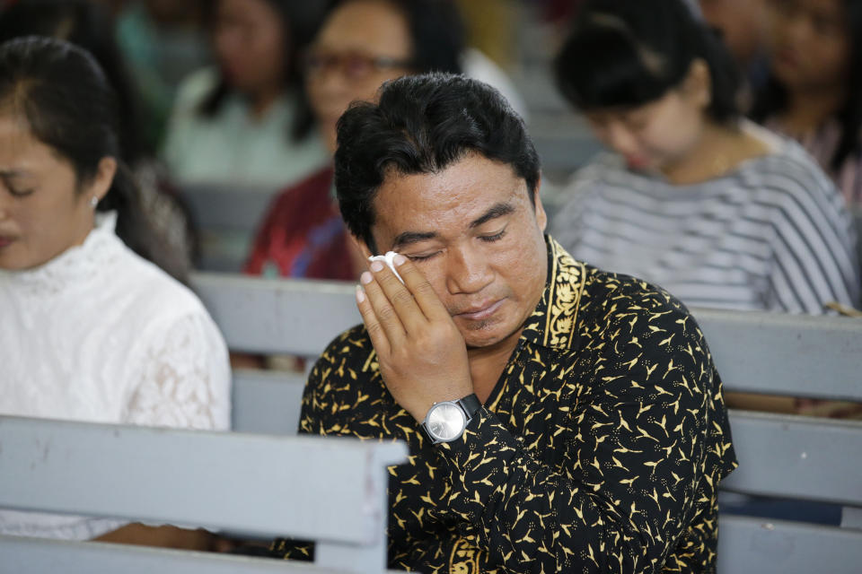 A Christian wipes tears from his eyes as he attends church at the earthquake and tsunami-hit town of Palu, Central Sulawesi, Indonesia Sunday, Oct. 7, 2018. Christians dressed in their tidiest clothes flocked to Sunday sermons in the earthquake and tsunami damaged Indonesian city of Palu, hoping for answers to the double tragedy that inflicted deep trauma on their community. (AP Photo/Aaron Favila)