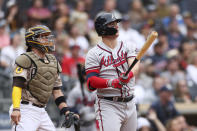 Atlanta Braves' Joc Pederson, right, watches his solo home run as San Diego Padres catcher Victor Caratini looks on in the second inning of a baseball game Sunday, Sept. 26, 2021, in San Diego. (AP Photo/Derrick Tuskan)