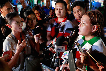 Rappler reporter Pia Ranada interviews Davao City Mayor Sara Duterte, the eldest daughter of President Rodrigo Duterte, after a campaign sortie in Calamba City, Laguna, Philippines, March 9, 2019. REUTERS/Eloisa Lopez