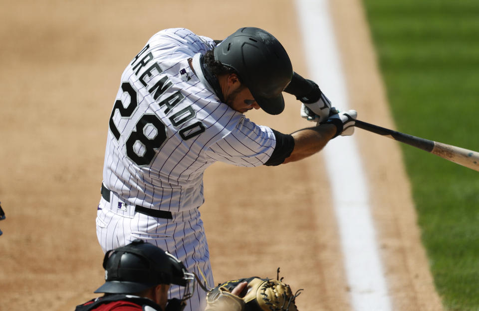 Colorado Rockies' Nolan Arenado connects for a solo home run off Arizona Diamondbacks relief pitcher Taylor Clarke in the fifth inning of a baseball game Wednesday, Aug. 12, 2020, in Denver. (AP Photo/David Zalubowski)