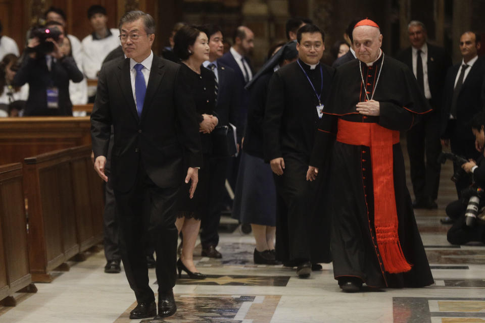 South Korean president Moon Jae-in arrives in St. Peter's Basilica for a Mass for Peace celebrated by Vatican Secretary of State Pietro Parolin at the Vatican, Wednesday, Oct. 17, 2018. South Korea's president is in Italy for a series of meetings that will culminate with an audience with Pope Francis at which he's expected to extend an invitation from North Korean leader Kim Jong Un to visit. (AP Photo/Gregorio Borgia)