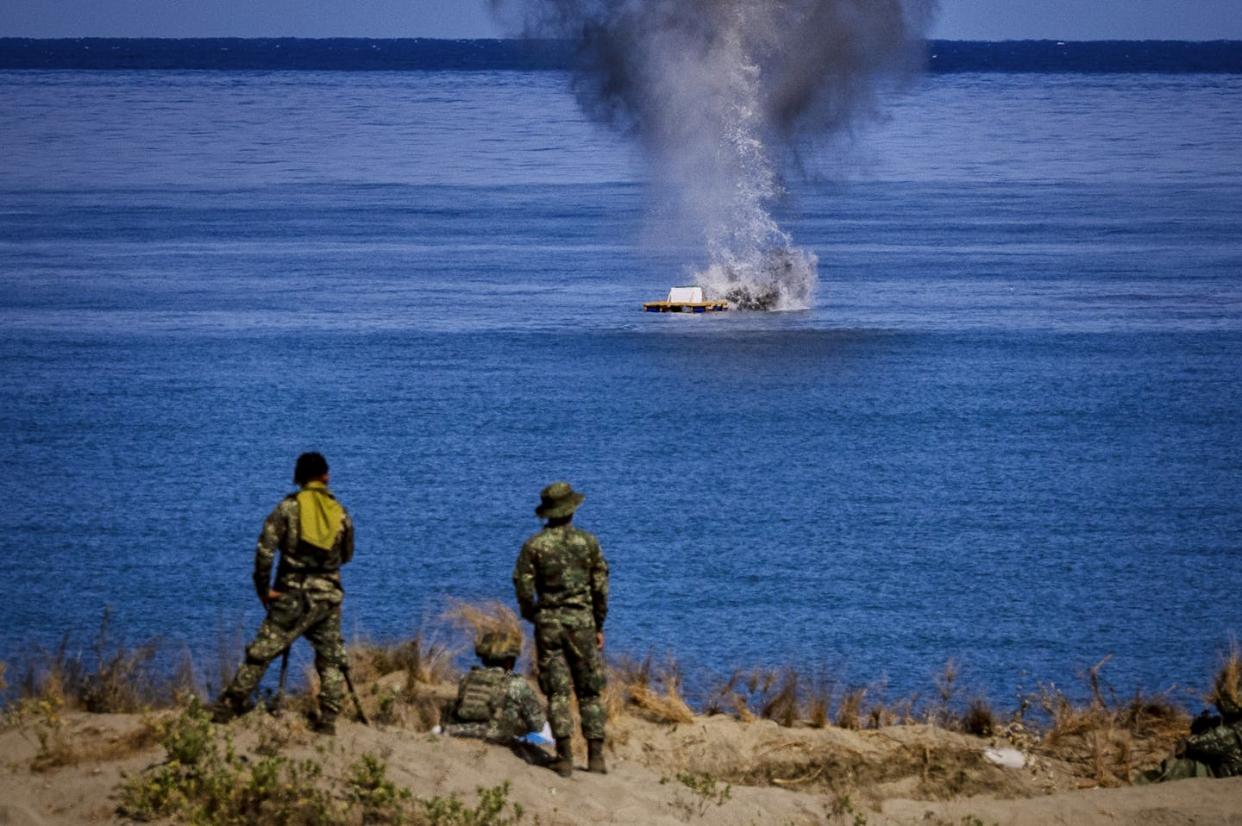 Philippine troops watch as a missile hits a target during a live-fire joint U.S.-Philippines exercise. <a href="https://www.gettyimages.com/detail/news-photo/philippine-troops-watch-as-a-javelin-missile-hits-a-target-news-photo/2151659044?adppopup=true" rel="nofollow noopener" target="_blank" data-ylk="slk:Ezra Acayan/Getty Images;elm:context_link;itc:0;sec:content-canvas" class="link ">Ezra Acayan/Getty Images</a>
