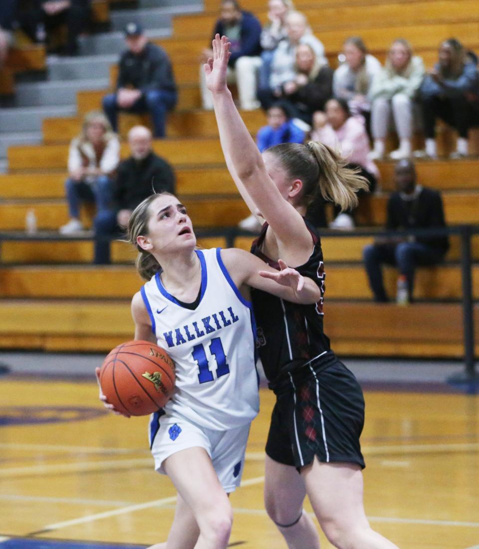 Wallkill's Zoe Mesuch drives to the basket against Albertus' Allie Falesto during the New York State Class AA regional girls basketball final versus Wallkill on March 8, 2024.