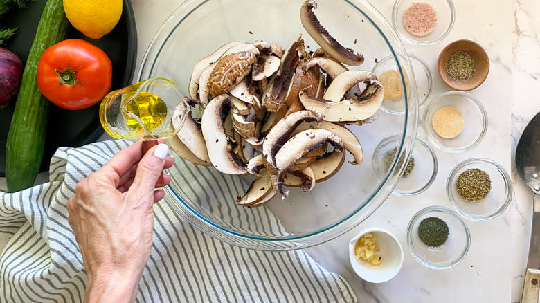adding oil to mushrooms
