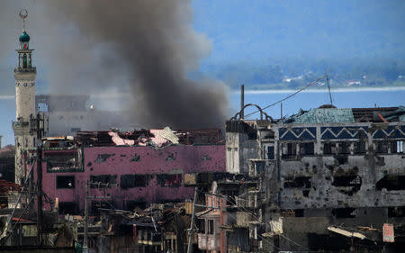 Smoke billows from a burning building as government troops continue their assault on its 105th day of clearing operations against pro-IS militants who have seized control of large parts of Marawi city, southern Philippines September 4, 2017. REUTERS/Romeo Ranoco