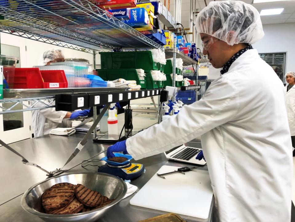 <div class="inline-image__caption"><p>Impossible Foods product development associate scientist Kyle Okada measures plant-based burgers tailor-made for Burger King at a facility in Redwood City, California, U.S. </p></div> <div class="inline-image__credit">JANE LANHEE LEE/REUTERS</div>