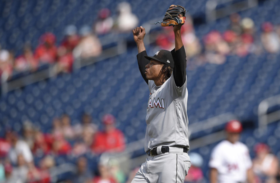 Miami Marlins starting pitcher Jose Urena begins to celebrate as he threw a complete baseball game against the Washington Nationals, Sunday, Aug. 19, 2018, in Washington. (AP Photo/Nick Wass)