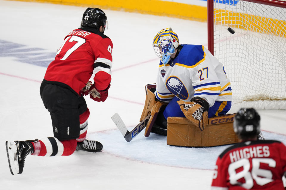 New Jersey Devils' Paul Cotter scores his sides second goal past Buffalo Sabres' Devon Levi during the NHL hockey game between Buffalo Sabres and New Jersey Devils, in Prague, Czech Republic, Saturday, Oct. 5, 2024. (AP Photo/Petr David Josek)