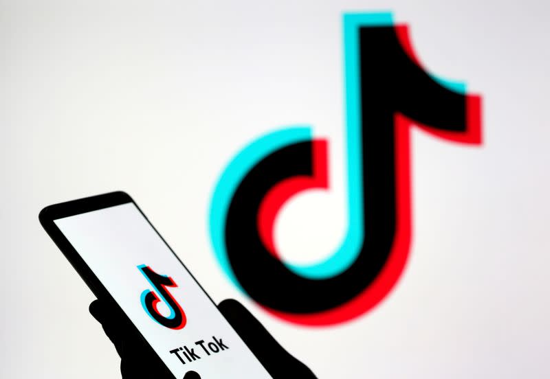FILE PHOTO: A person holds a smartphone with TikTok logo displayed in this picture illustration
