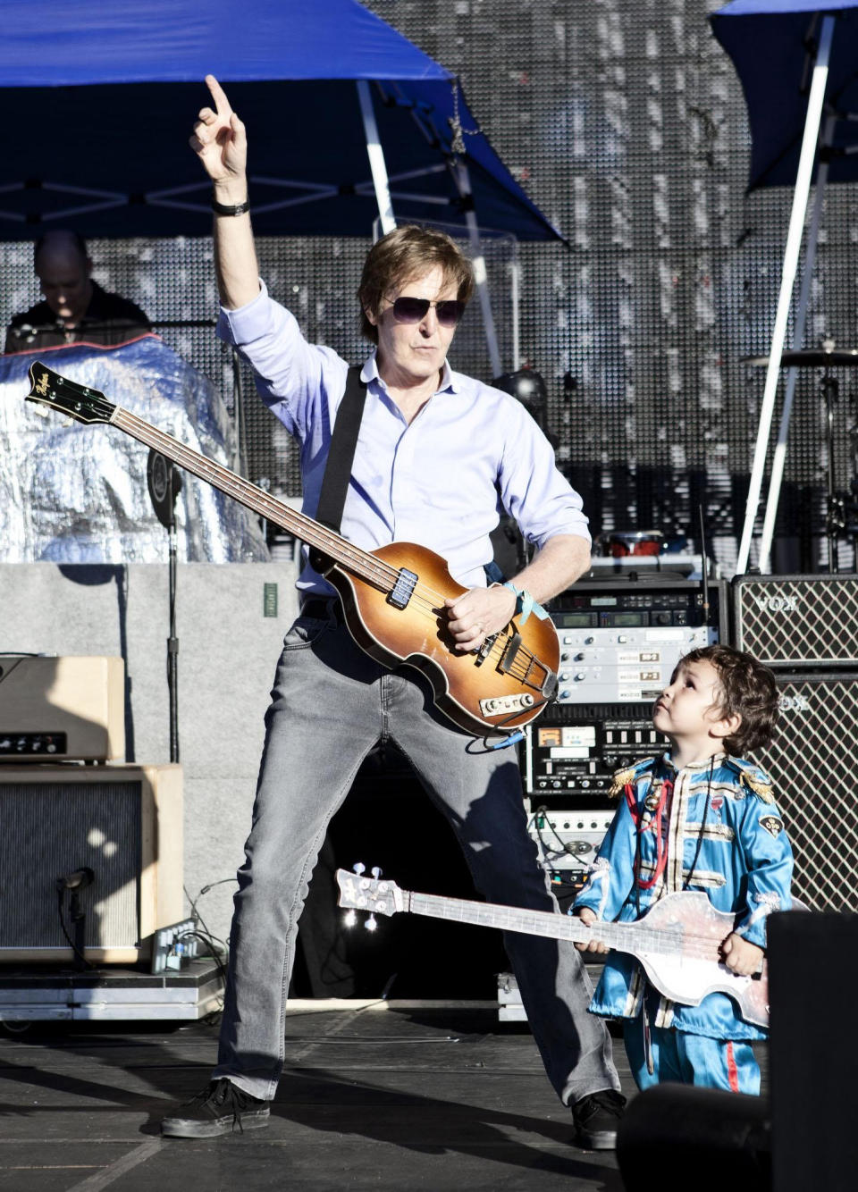 In this handout photo of Sir Paul McCartney with Ichiro who is dressed in his own Sgt Peppers outfit, on stage during a sound check ahead of his concert in Montevideo, Uruguay, Monday, April 16, 2012. The two year old boy had traveled with his parents all the way from Argentina and made himself known to the security team and was invited up on stage by Sir Paul himself. Ichiro even had his own miniature version of Sir Paul's iconic Hofner bass guitar and performed a version of 'Get Back'. (AP Photo/2012 MPL Communications/MJ Kim)