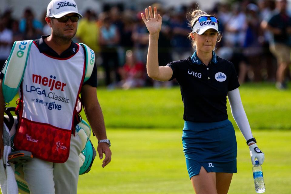 Nelly Korda waves to the crowd as she arrives on the 18th green for a playoff between herself, Jennifer Kupcho and Leona Maguire Sunday, June 19, 2022, at Blythefield Country Club in Belmont Michigan.