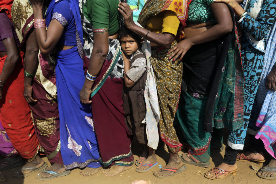 In this Dec. 5, 2018, file photo, a child waits in a queue for free food as thousands gather to mark Bhim Rao Ambedkar's death anniversary at Chaithyabhoomi in Mumbai, India. Ambedkar, an untouchable, was one of India's prominent freedom fighters and the chief architect of the Indian Constitution that outlawed discrimination based on caste. (AP Photo/Rajanish Kakade, File)