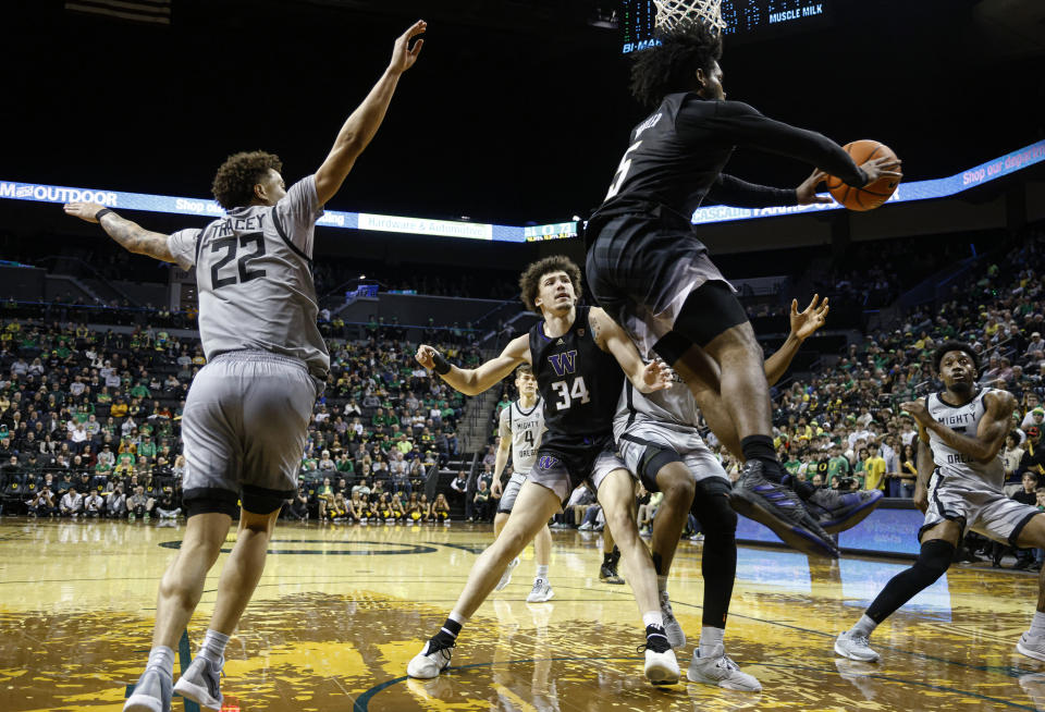 Washington guard Sahvir Wheeler (5) passes the ball during the second half of the team's NCAA college basketball game against Oregon in Eugene, Ore., Thursday, Feb. 8, 2024. (AP Photo/Thomas Boyd)