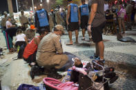 <p>Firefighter gives the first aid to a man that was hurt after a car drove into the crowded seaside boardwalk along Copacabana beach in Rio de Janeiro, Brazil, Thursday, Jan. 18, 2018. (Photo: Silvia Izquierdo/AP) </p>