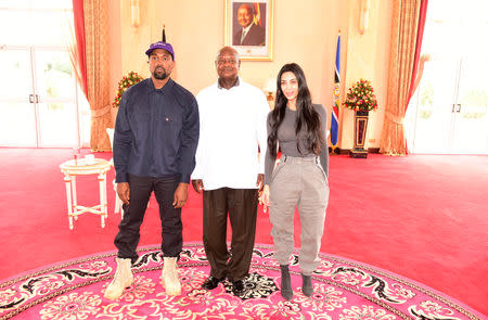 Rapper Kanye West (L) and Kim Kardashian (R) pose for a photograph with Uganda's President Yoweri Museveni when they paid a courtesy call at State House, Entebbe, Uganda October 15, 2018. Presidential Press Unit/Handout via REUTERS