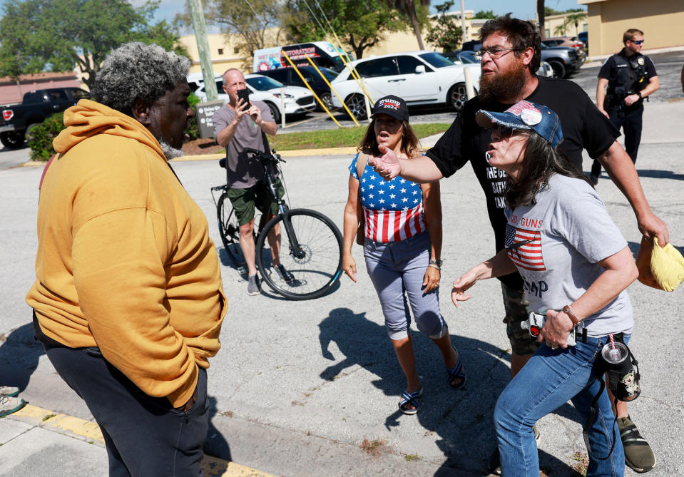 A supporter of President Joe Biden faces supporters of Donald Trump outside of the courthouse in Fort Pierce, Fla., where Trump attended a hearing in his classified records case on March 14. (Joe Raedle / Getty Images)